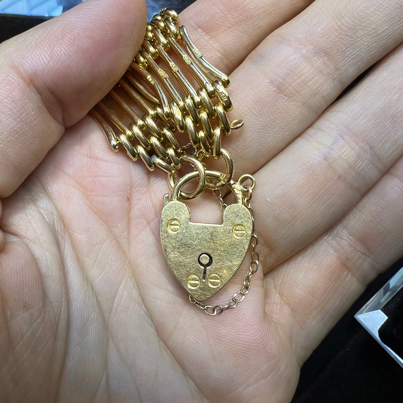 close up of heart shaped padlock om 18 carat bracelet