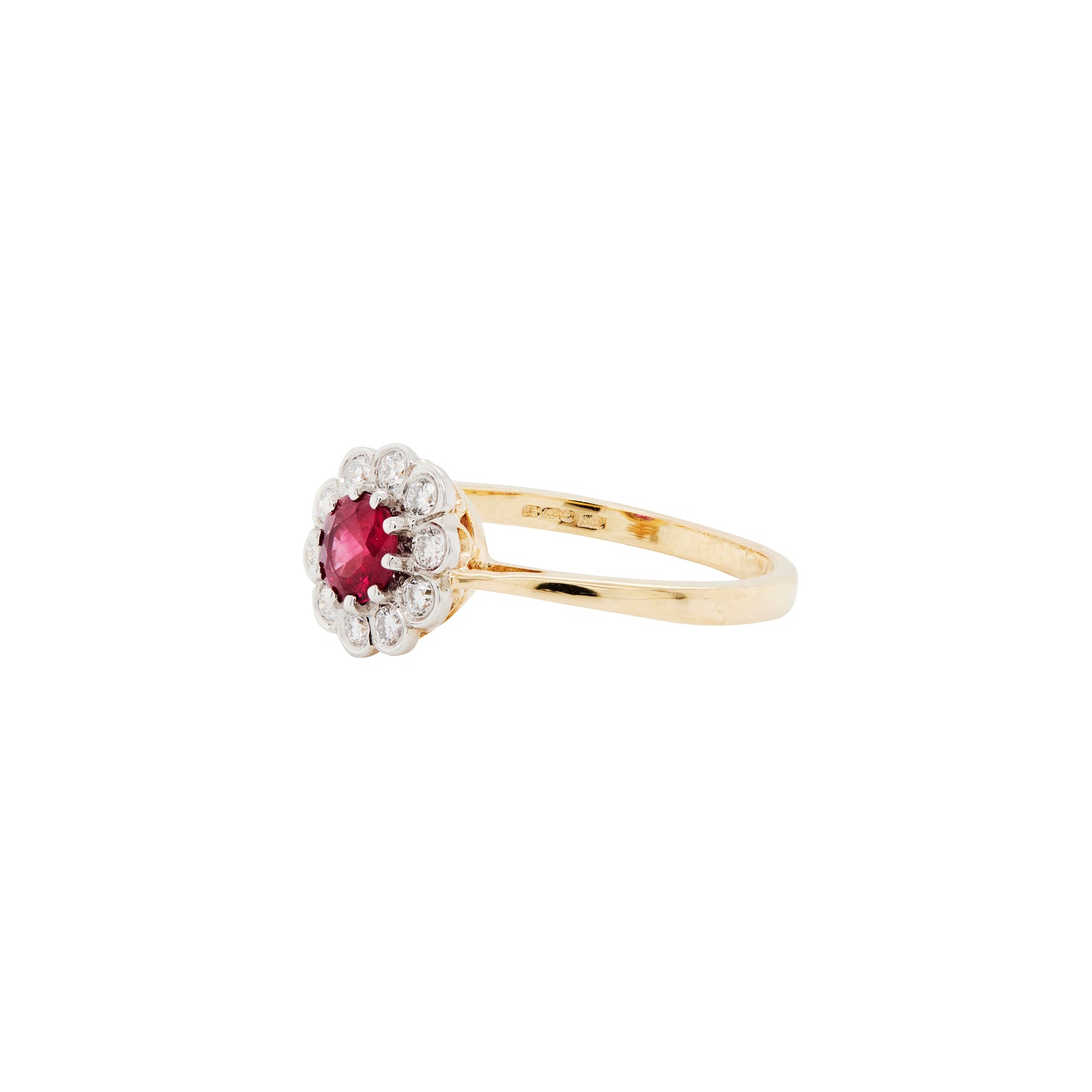 Gold ring with a red gemstone and diamond accents on a white background