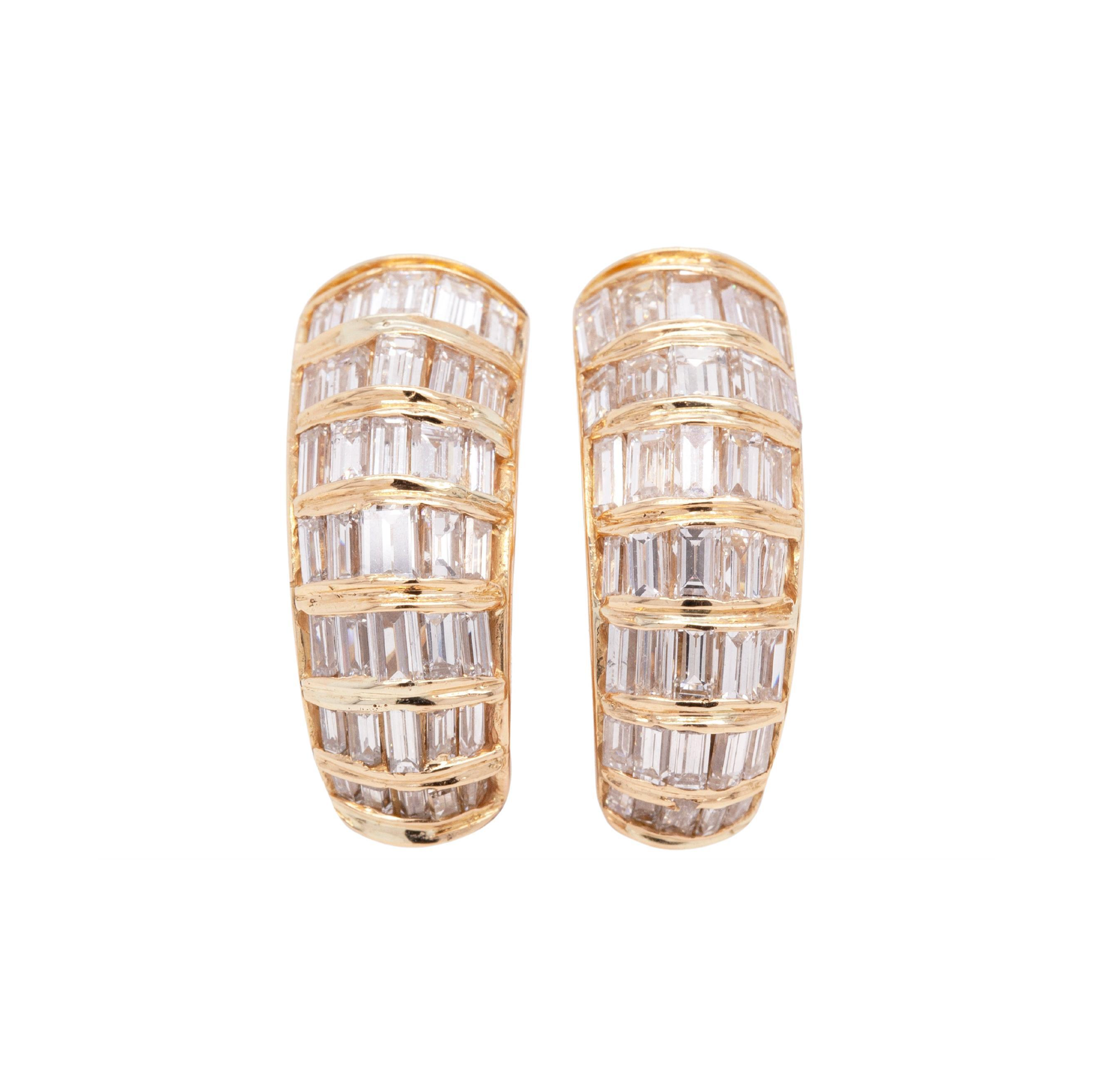 A pair of 18 carat yellow gold dome-shaped earrings with baguette cut diamonds.