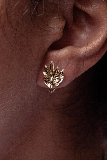 lady wearing a leaf motif 18 carat gold earring
