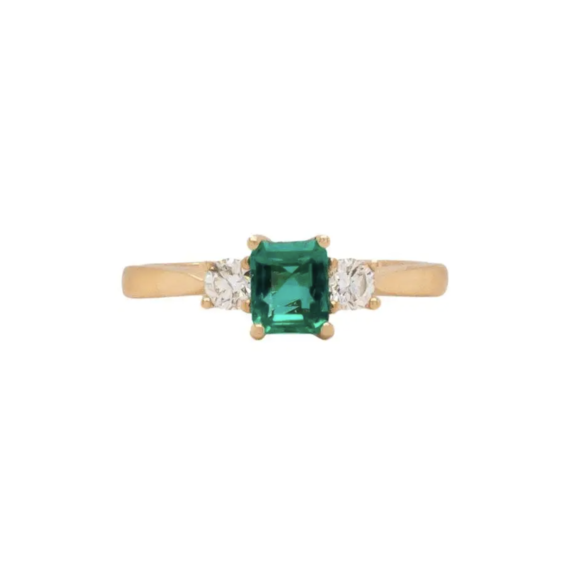 An 18K yellow gold three stone engagement ring featuring a rectangular emerald cut Colombian emerald center stone flanked by two round brilliant cut diamonds.