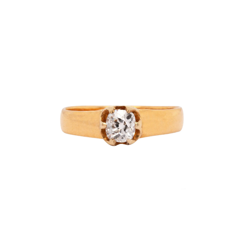 An antique old mine cut diamond and 22 carat yellow gold solitaire engagement ring with a visible ring band.
