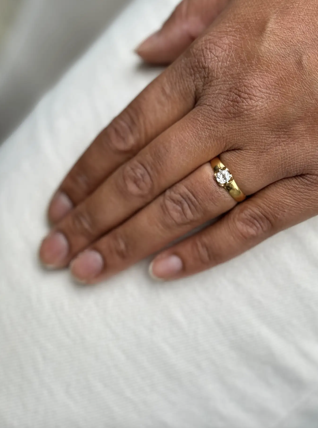 lady wearing an Antique Old Mine Cut Diamond and 22 Carat Yellow Gold Solitaire Engagement Ring