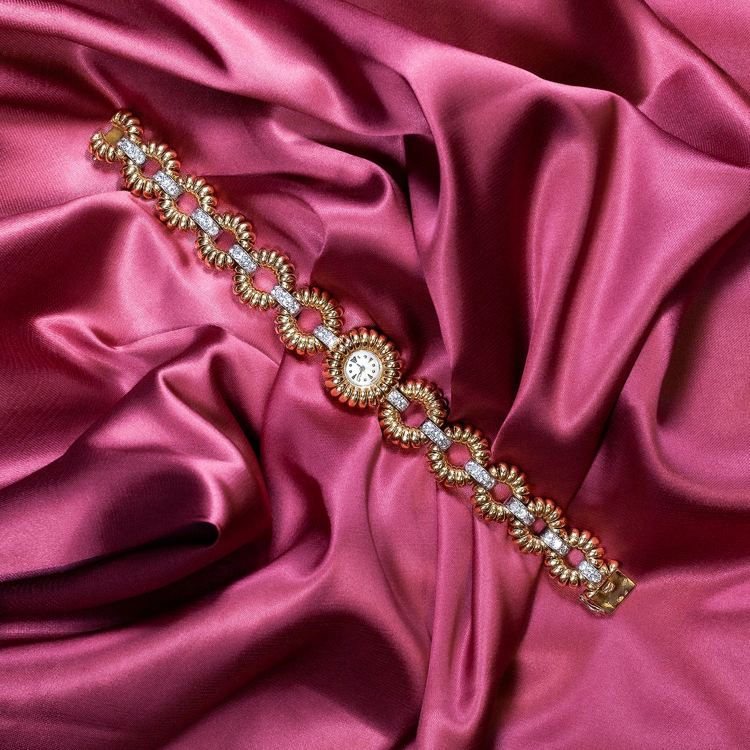 Tobi Gem - background banner diamond gold watch on a pink silk fabric 