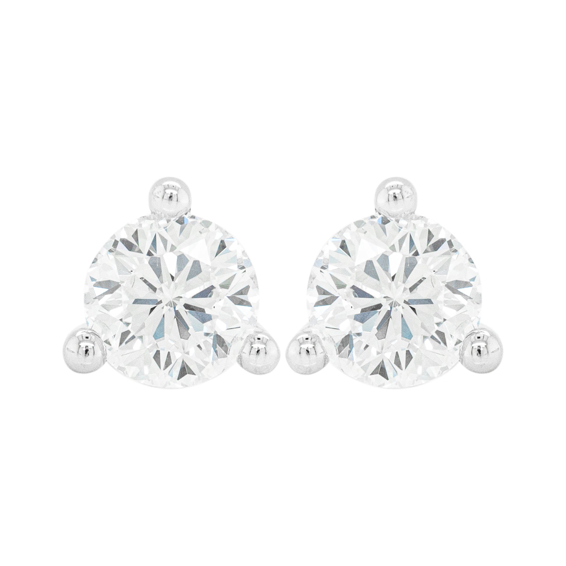 A pair of 18 carat white gold stud earrings with a clear, heart-shaped butterfly back and a central diamond.