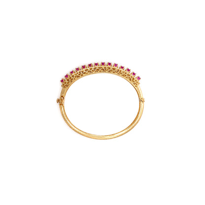 Vintage Ruby and 14 Carat Yellow Gold Open Work Hinged Bangle, circa 1980s