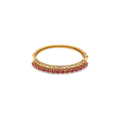 Vintage Ruby and 14 Carat Yellow Gold Open Work Hinged Bangle, circa 1980s