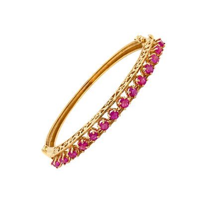 Vintage Ruby and 14 Carat Yellow Gold Open Work Hinged Bangle, circa 1980s