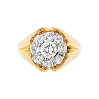 A vintage diamond 18 carat yellow gold cluster ring with a central diamond cluster surrounded by smaller round brilliant cut diamonds set in an 18 carat yellow gold mounting.
