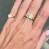 An 18 carat yellow gold lattice band ring with round brilliant cut diamond on hand