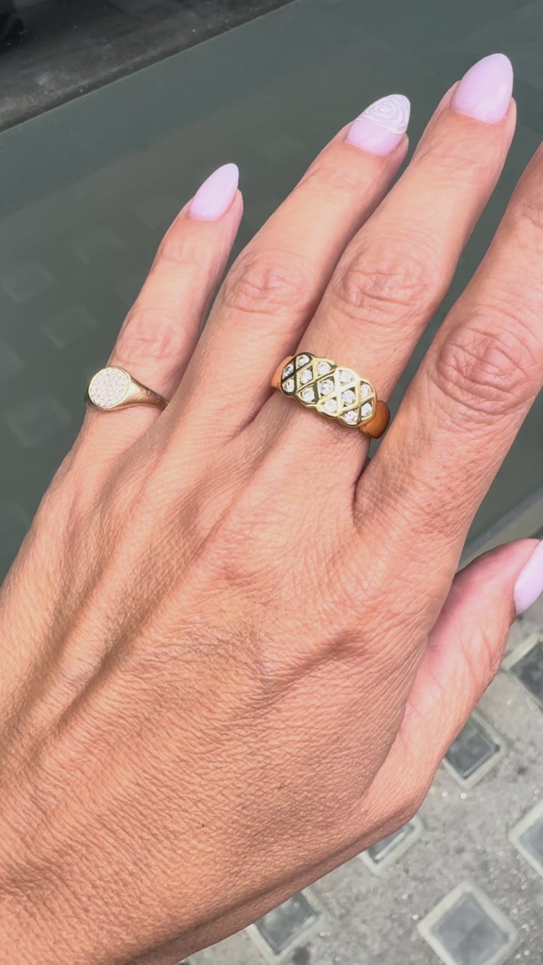 An 18 carat yellow gold lattice band ring with round brilliant cut diamond on hand