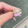 An 18 carat yellow gold lattice band ring with round brilliant cut diamond on hand
