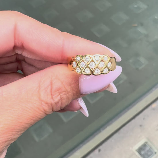 An 18 carat yellow gold lattice band ring with round brilliant cut diamond on hand