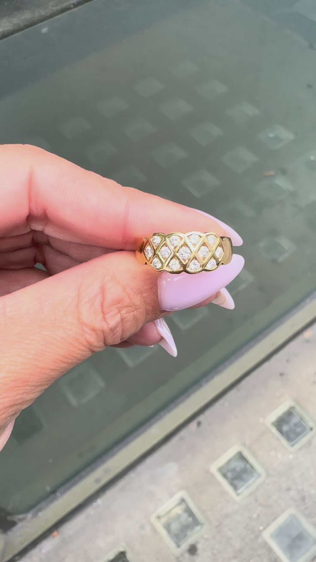 An 18 carat yellow gold lattice band ring with round brilliant cut diamond on hand