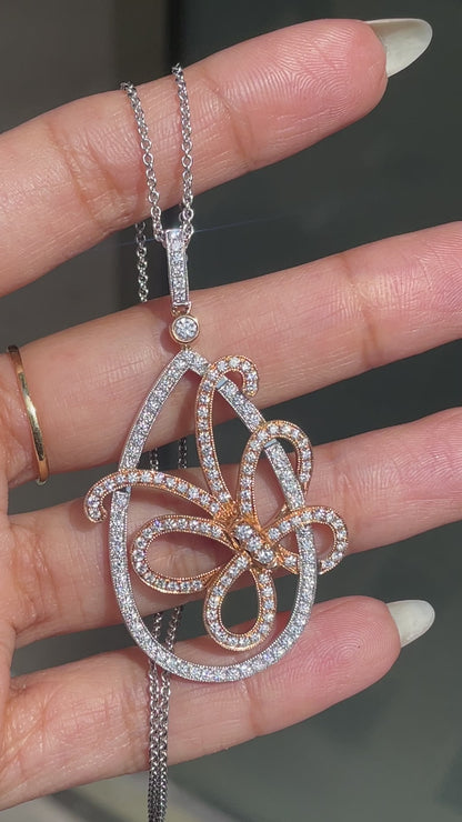 An 18 carat white and rose gold diamond butterfly pendant with a chain. 
