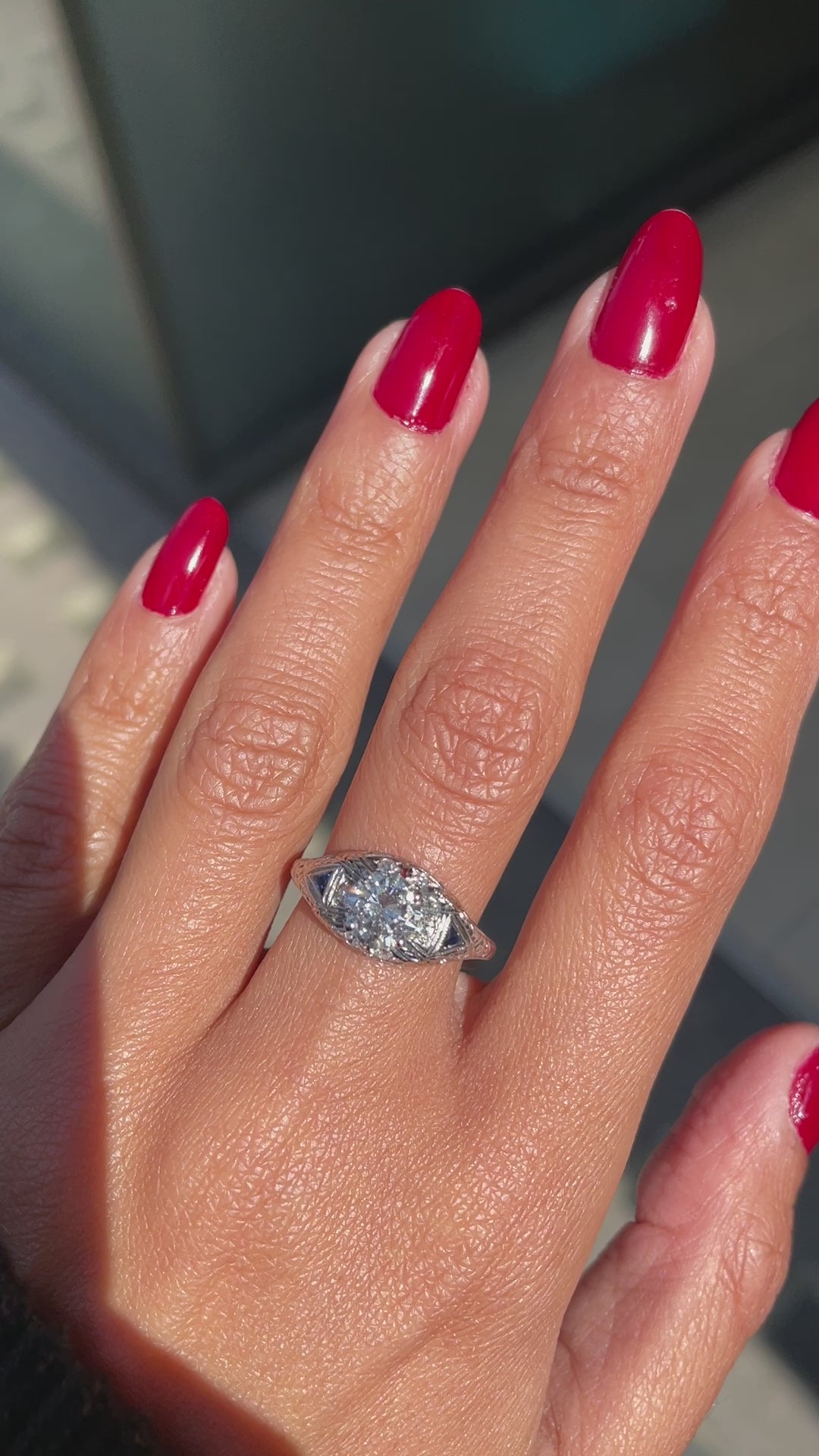 Video of a hand-carved platinum engagement ring with a round brilliant cut diamond centerpiece