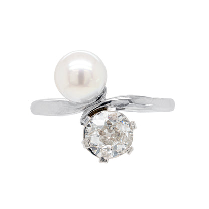 An antique pearl and diamond toi et moi engagement ring set in a white gold band