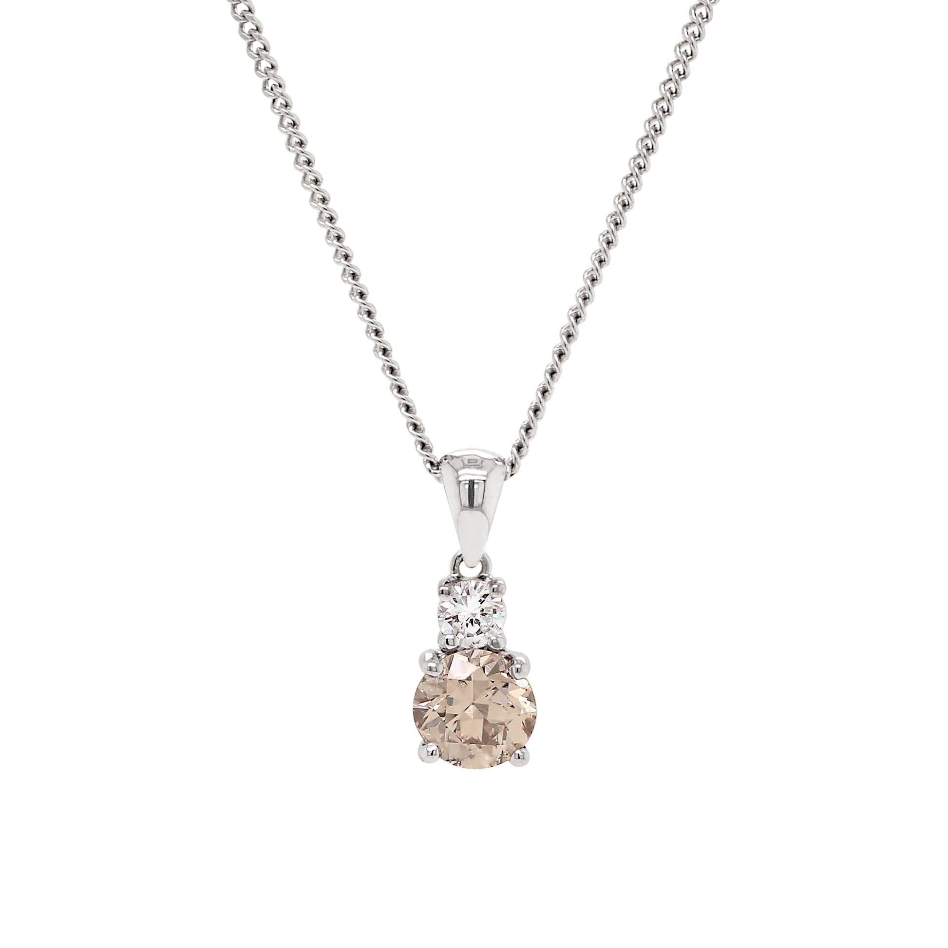 An 18 carat white gold two-stone pendant featuring a round brilliant cut brown diamond and a round brilliant cut white diamond, with a silver chain.