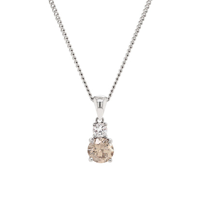 An 18 carat white gold two-stone pendant featuring a round brilliant cut brown diamond and a round brilliant cut white diamond, with a silver chain.